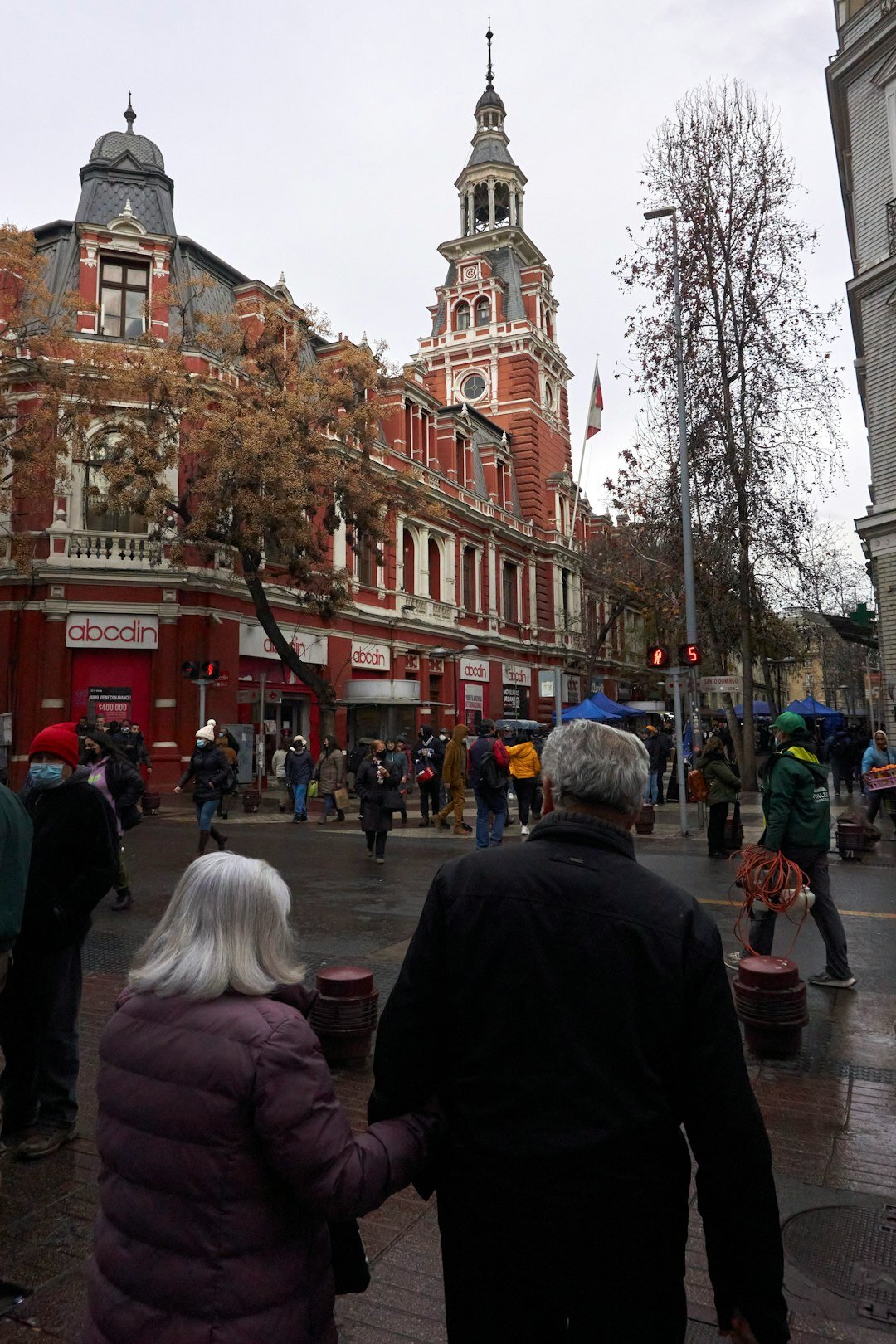 Busy street market in a Chilean city with vendors and pedestrians
